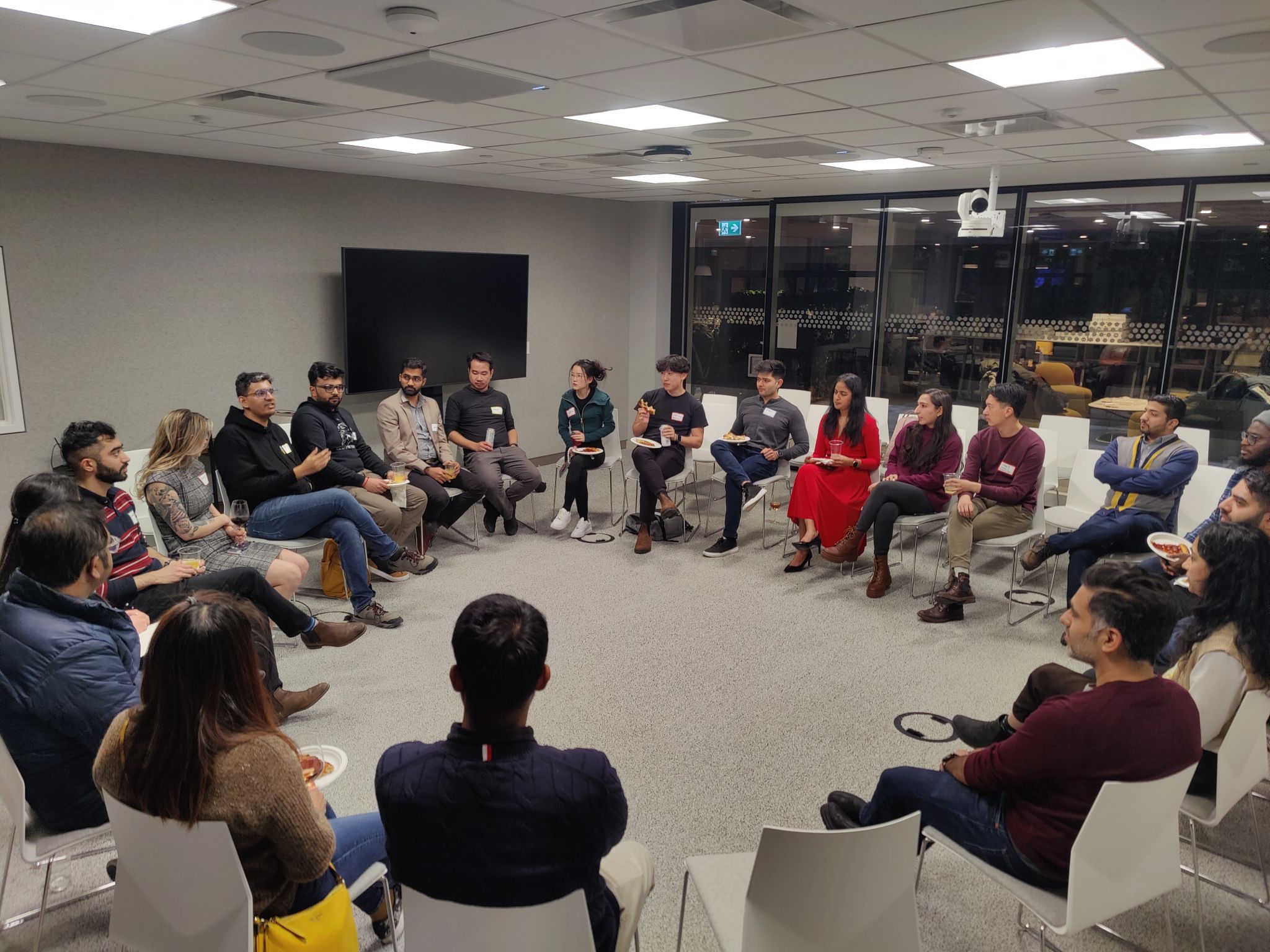 A group of product managers having a discussion in a circle.